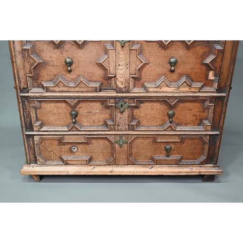 933 - A Jacobean oak chest of four long irregularly graduated drawers, with applied geometric mouldings an... 