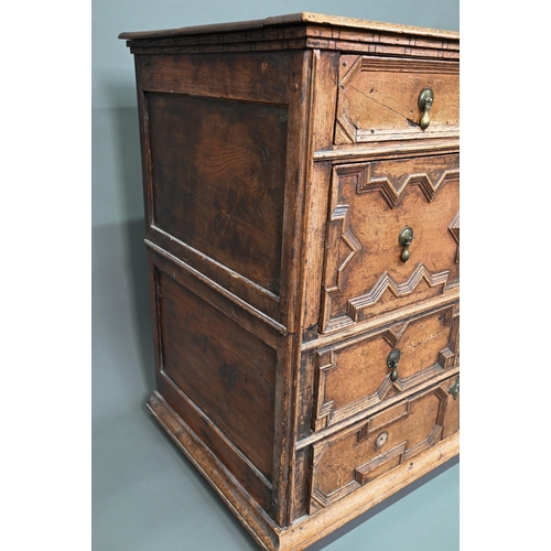 933 - A Jacobean oak chest of four long irregularly graduated drawers, with applied geometric mouldings an... 