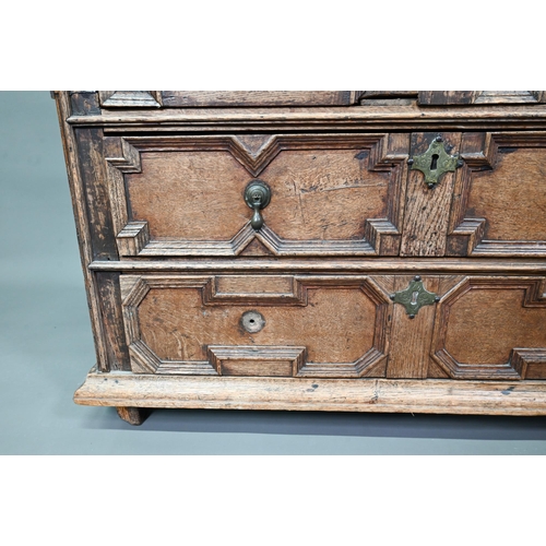 933 - A Jacobean oak chest of four long irregularly graduated drawers, with applied geometric mouldings an... 