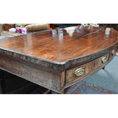 935 - A Victorian mahogany bow-fronted sideboard with three drawers, raised on square tapering legs to spa... 