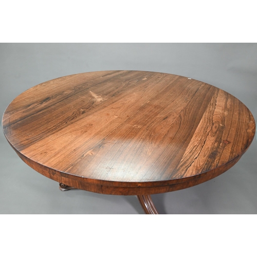 941 - A Victorian rosewood breakfast table, the circular tilt top raised on four moulded swept legs to scr... 