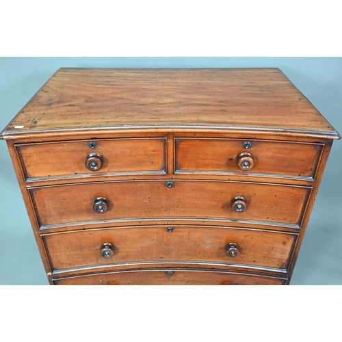 944 - A Georgian mahogany concave chest of two short over three long graduated drawers, with turned handle... 