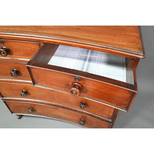 944 - A Georgian mahogany concave chest of two short over three long graduated drawers, with turned handle... 