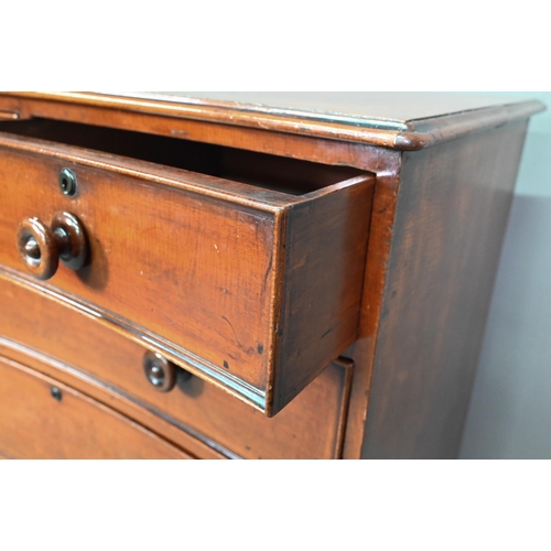 944 - A Georgian mahogany concave chest of two short over three long graduated drawers, with turned handle... 