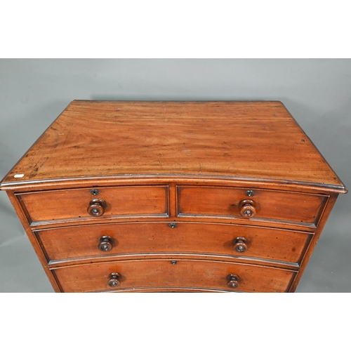 944 - A Georgian mahogany concave chest of two short over three long graduated drawers, with turned handle... 