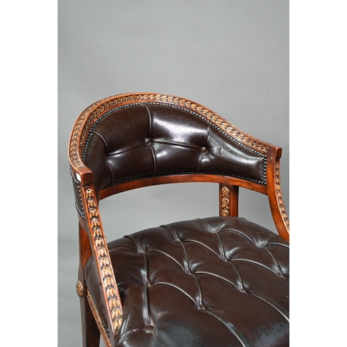 950 - Theodore Alexander, a part gilt decorated neo-classical style buttoned brown leather chair