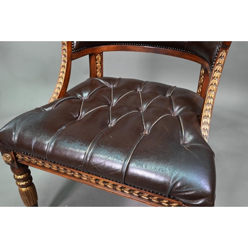 950 - Theodore Alexander, a part gilt decorated neo-classical style buttoned brown leather chair