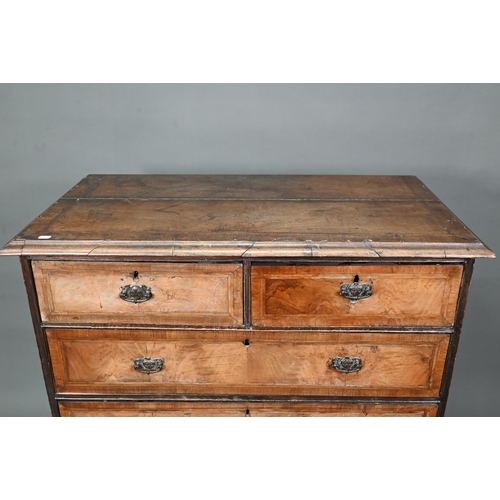 953 - An 18th century cross-banded walnut chest of two short over three long graduated drawers, raised on ... 