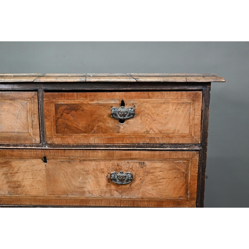 953 - An 18th century cross-banded walnut chest of two short over three long graduated drawers, raised on ... 