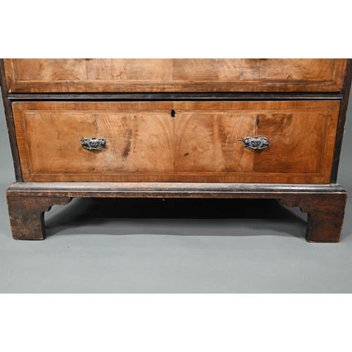 953 - An 18th century cross-banded walnut chest of two short over three long graduated drawers, raised on ... 