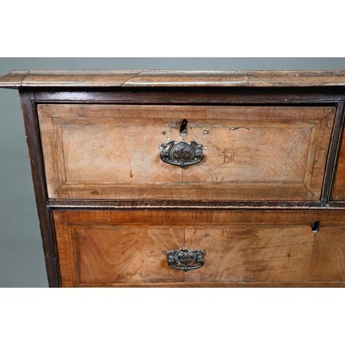 953 - An 18th century cross-banded walnut chest of two short over three long graduated drawers, raised on ... 