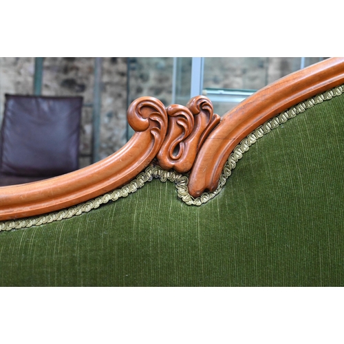 954 - A late Victorian walnut framed single scroll end chaise, upholstered in green dralon, raised on turn... 