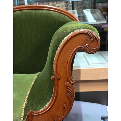 954 - A late Victorian walnut framed single scroll end chaise, upholstered in green dralon, raised on turn... 