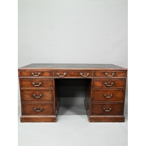 956 - An antique mahogany twin pedestal desk, the leathercloth inset top over an arrangement of nine drawe... 