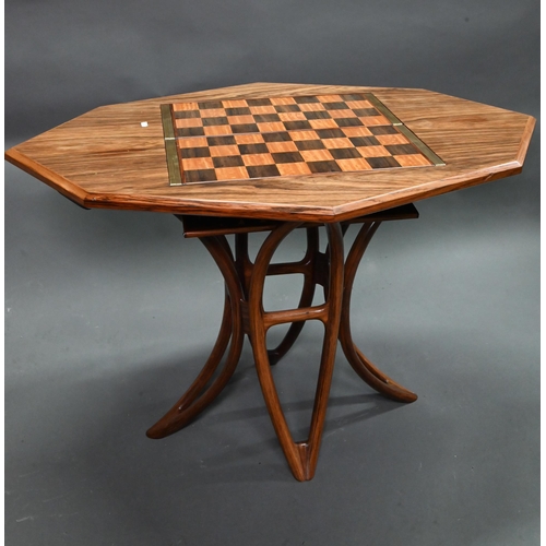 Declan O'Donoghue for S.F Furniture, an outstanding and unique bespoke elongated octagonal games table, executed in Indian rosewood, Andaman padouk, satinwood, laburnum and leather, the double pivoting boards for four games, chess, backgammon, bridge and cards, awarded The Guild Mark (No.87) by the Worshipful Company of Furniture Makers, 1987, the table widely featured in publications and exhibited to/w associated makers ephemera, documents and hardback publication, British Craftmanship in Wood, Norbury B. in which this table is also featured, 99 cm x 66 cm x 56 cm h