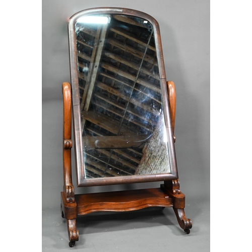 960 - A Victorian mahogany cheval mirror, the arched mirror plate raised above a platform base, on moulded... 