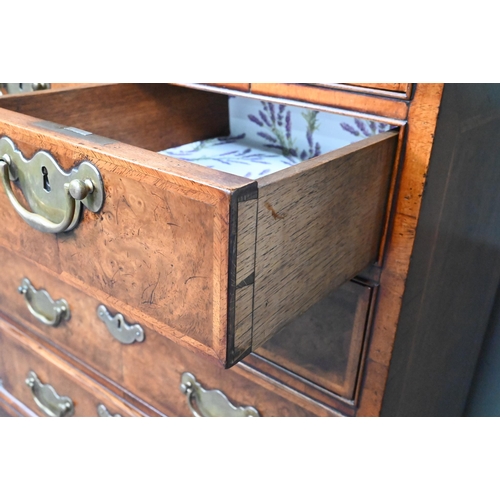 961 - A good reproduction George II style feather-banded chest of drawers, the full width brush slide over... 