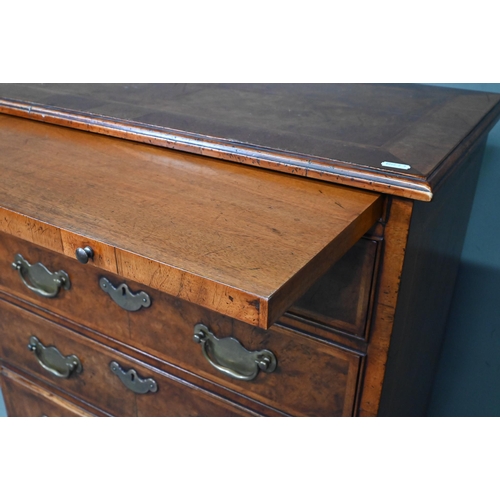 961 - A good reproduction George II style feather-banded chest of drawers, the full width brush slide over... 