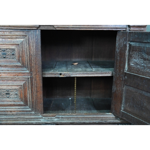 965 - A 17th century jointed oak cupboard, with two moulded panelled doors over a full width drawer, raise... 