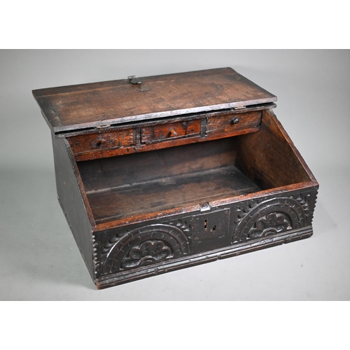 966 - A 17th century oak bible box, the iron hinged slope enclosing three drawers over a storage well, the... 