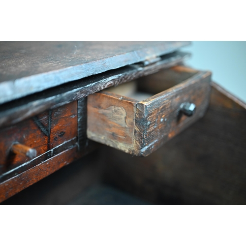 966 - A 17th century oak bible box, the iron hinged slope enclosing three drawers over a storage well, the... 