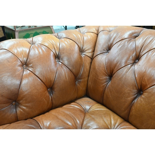 967 - A large contemporary antiqued buttoned brown leather Chesterfield style sofa and matching armchair, ... 