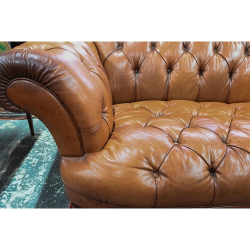 967 - A large contemporary antiqued buttoned brown leather Chesterfield style sofa and matching armchair, ... 