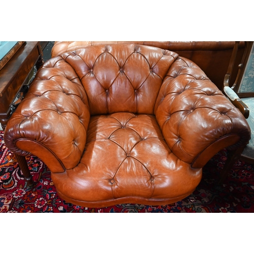 967 - A large contemporary antiqued buttoned brown leather Chesterfield style sofa and matching armchair, ... 