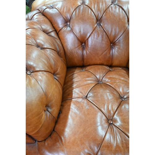 967 - A large contemporary antiqued buttoned brown leather Chesterfield style sofa and matching armchair, ... 