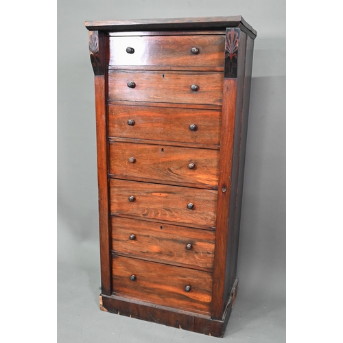 972 - A Victorian rosewood seven drawer Wellington chest, each with twin turned knobs, raised on a plinth ... 