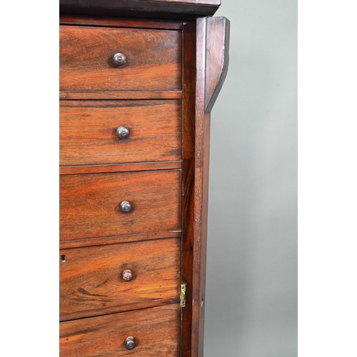 972 - A Victorian rosewood seven drawer Wellington chest, each with twin turned knobs, raised on a plinth ... 