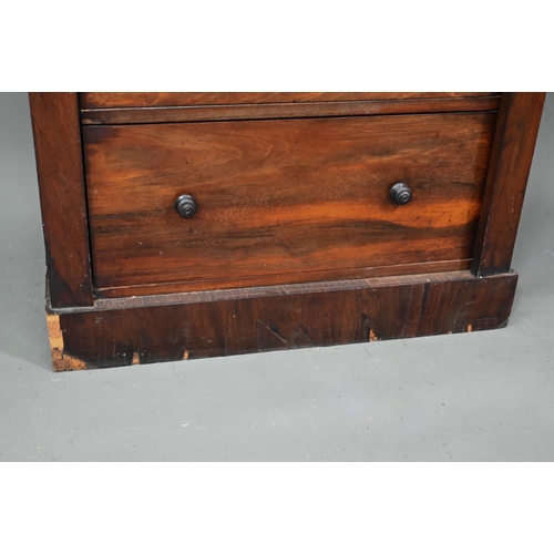 972 - A Victorian rosewood seven drawer Wellington chest, each with twin turned knobs, raised on a plinth ... 