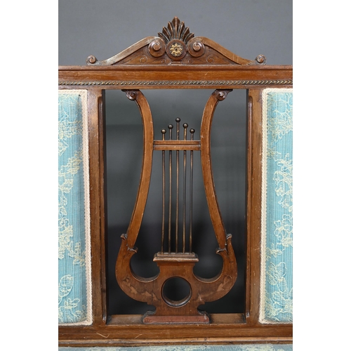 973 - An Edwardian walnut framed salon sofa, the back centred by a lyre splat flanked by fabric backrests,... 