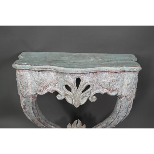 981 - An antique distress painted serpentine form console table, carved pine, raised on twin scroll legs u... 