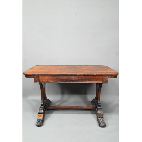 982 - A William IV rosewood library table, with single long frieze drawer, raised on twin scroll end suppo... 