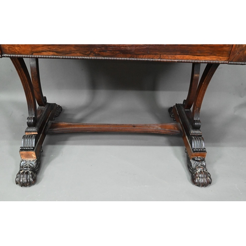 982 - A William IV rosewood library table, with single long frieze drawer, raised on twin scroll end suppo... 