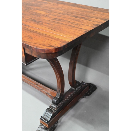 982 - A William IV rosewood library table, with single long frieze drawer, raised on twin scroll end suppo... 