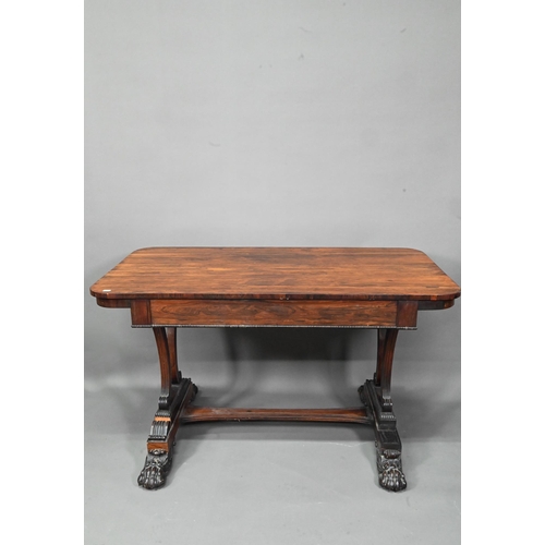 982 - A William IV rosewood library table, with single long frieze drawer, raised on twin scroll end suppo... 