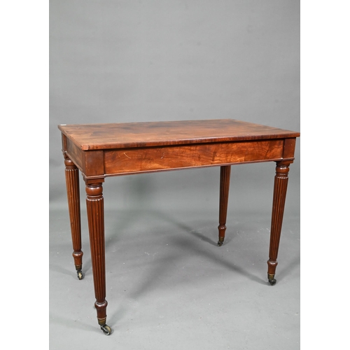 983 - A Victorian mahogany two drawer side table, raised on turned reeded legs to brass castors, 91 cm w x... 