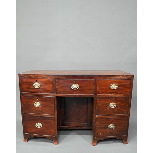 988 - A Victorian mahogany bowfront kneehole desk, with six drawers and recessed cupboard, raised on splay... 