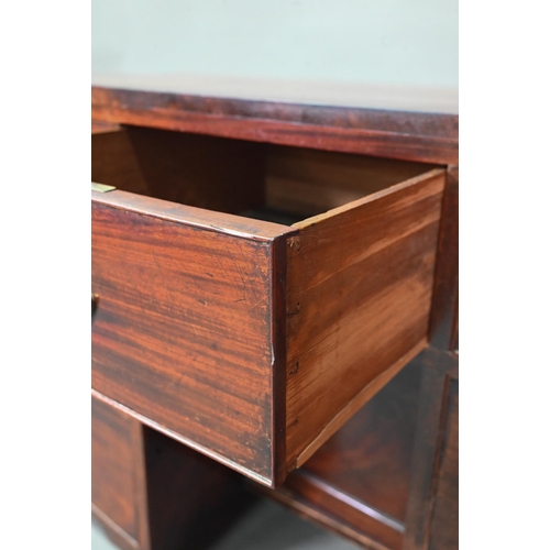 988 - A Victorian mahogany bowfront kneehole desk, with six drawers and recessed cupboard, raised on splay... 