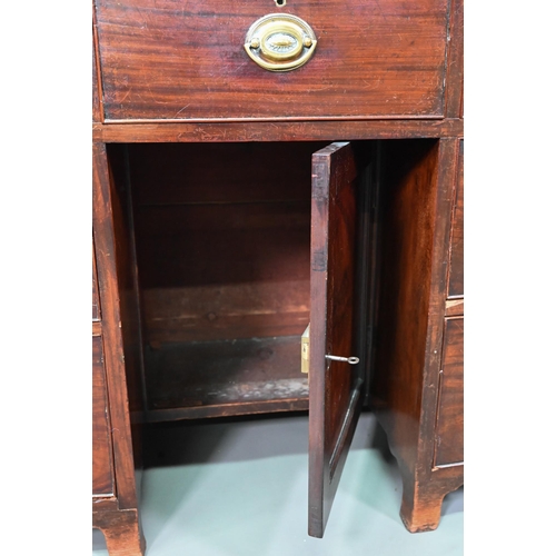 988 - A Victorian mahogany bowfront kneehole desk, with six drawers and recessed cupboard, raised on splay... 