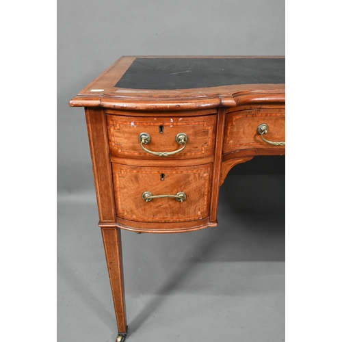 994 - A late 19th century cross-banded satinwood desk, the top with leather surface over five drawers, rai... 