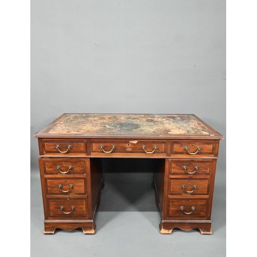 997 - Maple & Co. Ltd. a Victorian mahogany twin pedestal desk, the battered leather top over nine dra... 