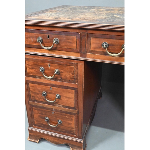 997 - Maple & Co. Ltd. a Victorian mahogany twin pedestal desk, the battered leather top over nine dra... 