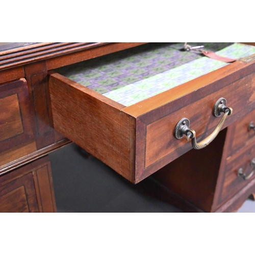 997 - Maple & Co. Ltd. a Victorian mahogany twin pedestal desk, the battered leather top over nine dra... 