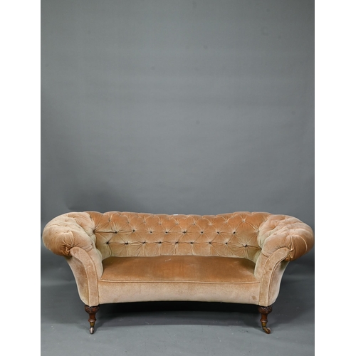 998 - A Victorian button upholstered sofa, raised on moulded and turned walnut front lets, on ceramic cast... 