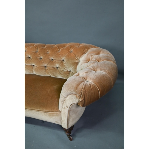 998 - A Victorian button upholstered sofa, raised on moulded and turned walnut front lets, on ceramic cast... 