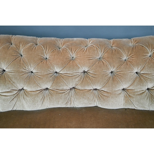 998 - A Victorian button upholstered sofa, raised on moulded and turned walnut front lets, on ceramic cast... 