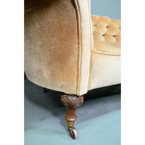 998 - A Victorian button upholstered sofa, raised on moulded and turned walnut front lets, on ceramic cast... 